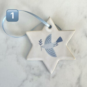 Handgjort julgranshänge i keramik i form av Davidsstjärna med blått band – dekorerat med fredsduva som bär olivkvist.