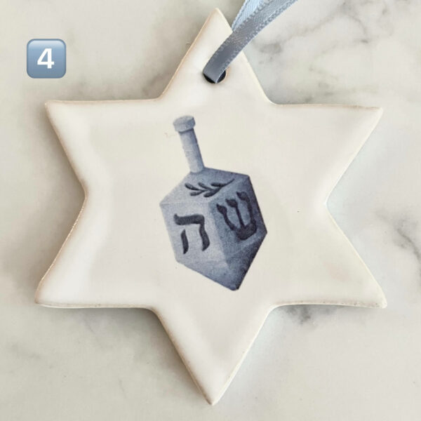 Handgjort julgranshänge i keramik i form av Davidsstjärna med blått band – dekorerat med en blå dreidel